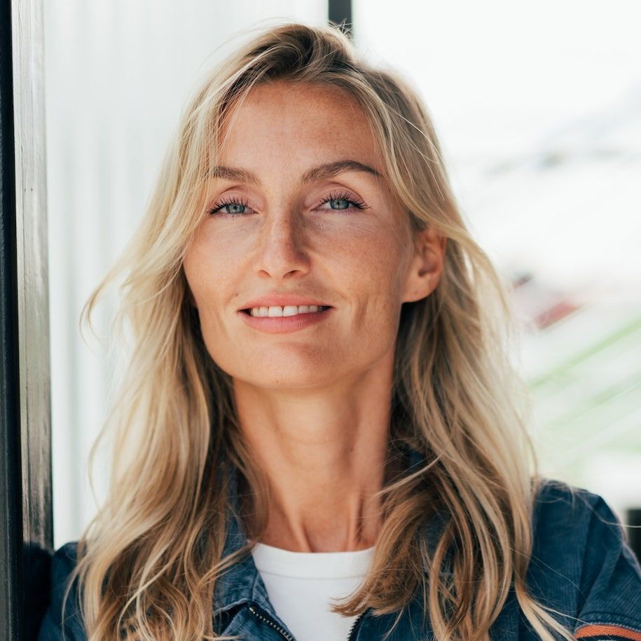 Testimonial portrait of a beautiful woman standing with her arms crossed.